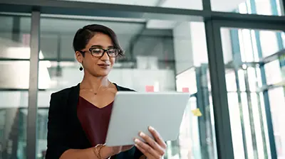 Business woman with eye glasses using a tablet