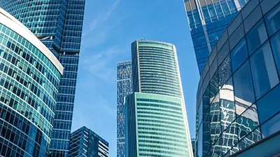 Multiple tall skyscrapers  with the blue sky in the background 